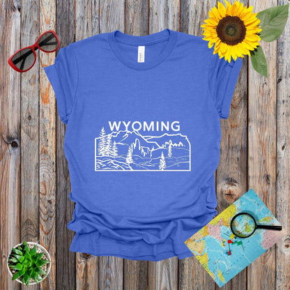 a t - shirt with the words wyoming on it next to a sunflower