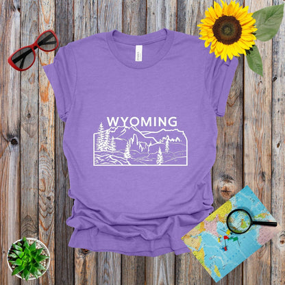 a t - shirt with the words wyoming on it next to a sunflower