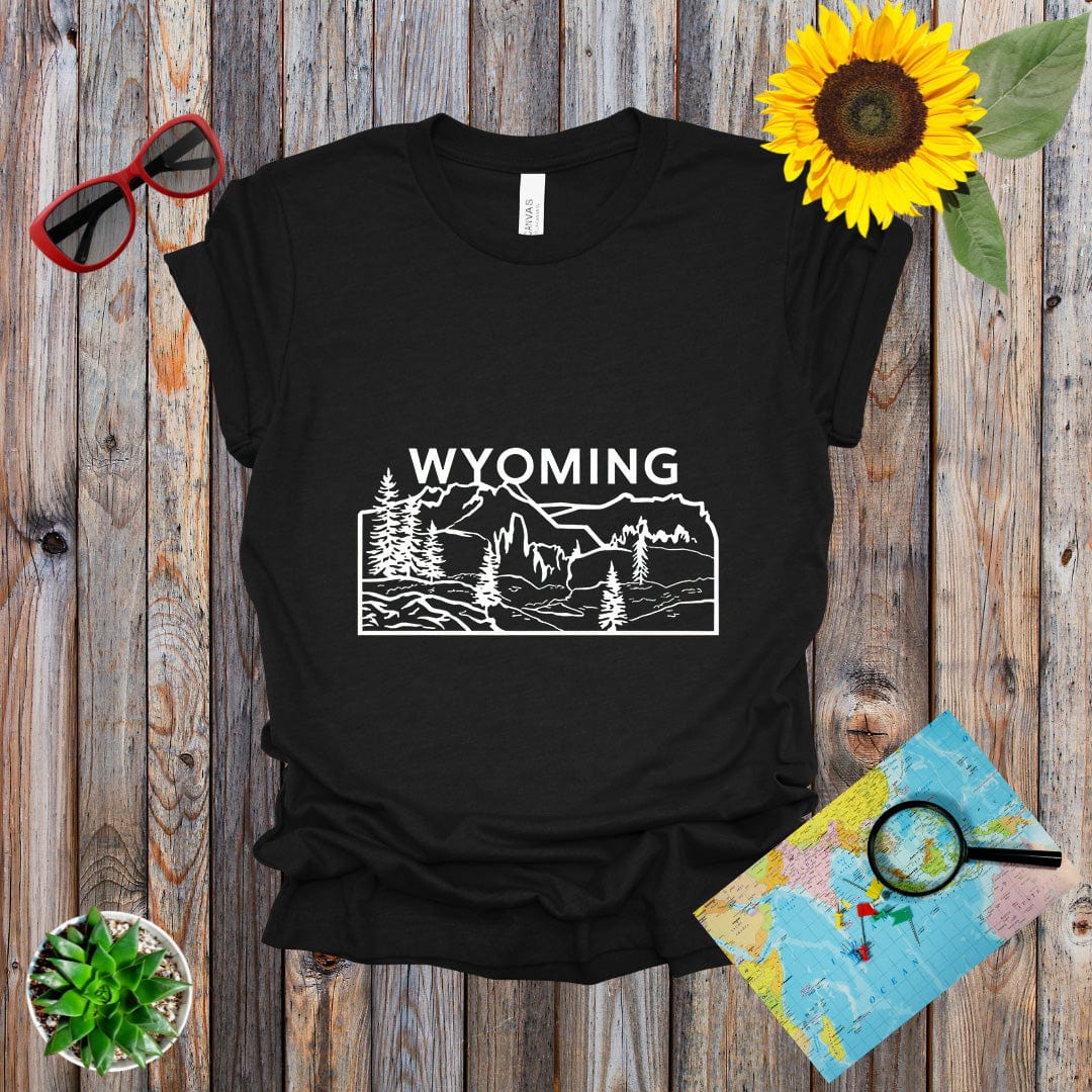 a t - shirt with the words wyoming on it next to a sunflower