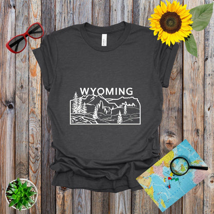 a t - shirt with the words wyoming on it next to a sunflower