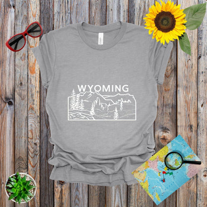 a t - shirt with the words wyoming on it next to a sunflower